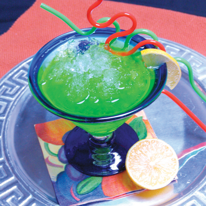 Colorful cocktail with flaked ice from Hoshizaki icemaker in a blue-rimmed glass, garnished with a lemon slice and curly straws.