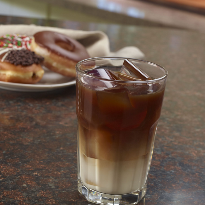 Hoshizaki KM-1340MRJZ crescent cuber icemaker with coffee and donuts on a counter.