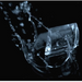 Crescent-shaped ice cubes produced by Hoshizaki KM-1340MRJZ3 icemaker splashing in water.